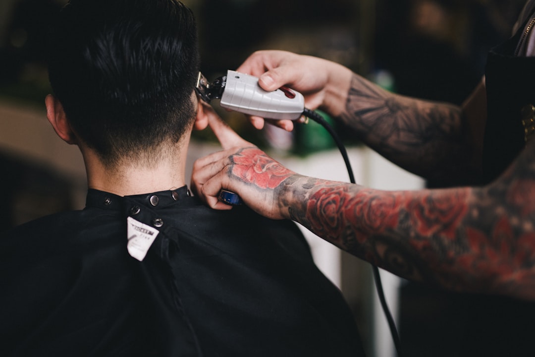 Is it some kind of rule that barbers must have full-sleeve tattoos? Photo by  Hai Phung  on  Unsplash